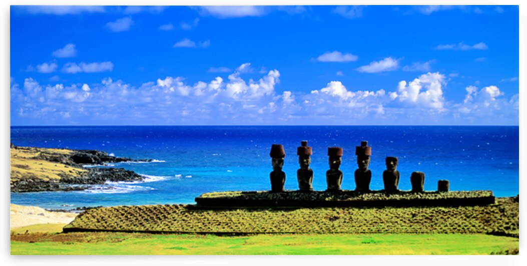 Easter Island Moai statues against a vibrant blue ocean and sky. by Marco Brivio
