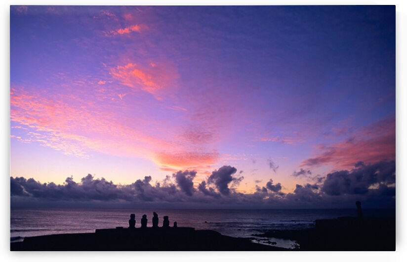 Moai silhouettes against a stunning purple and pink sunset. by Marco Brivio