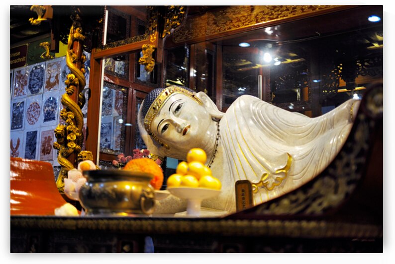 Reclining Buddha statue in temple with offerings in Shanghai by Marco Brivio