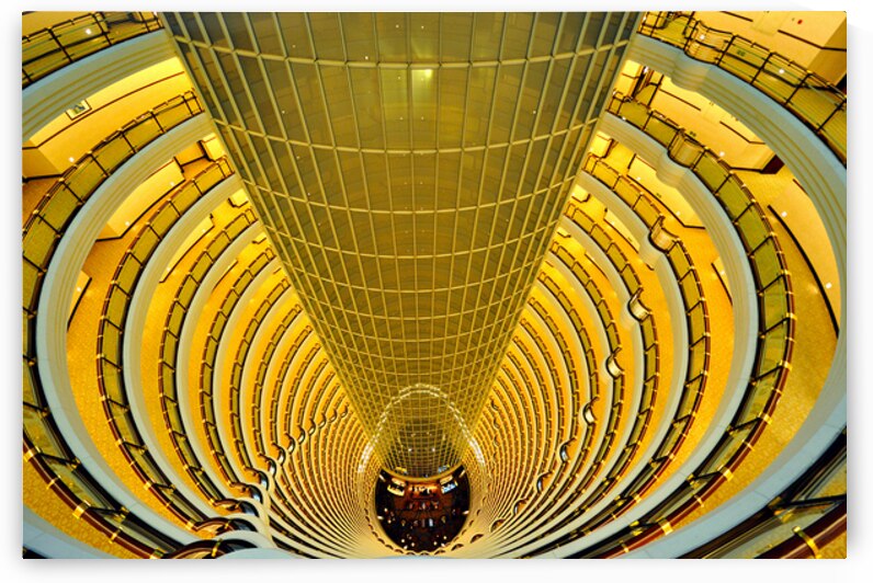 Golden hotel atrium with glass elevator in Shanghai China by Marco Brivio