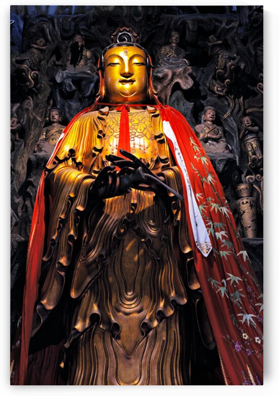 A golden Buddha statue stands in Shanghai wearing a red robe by Marco Brivio