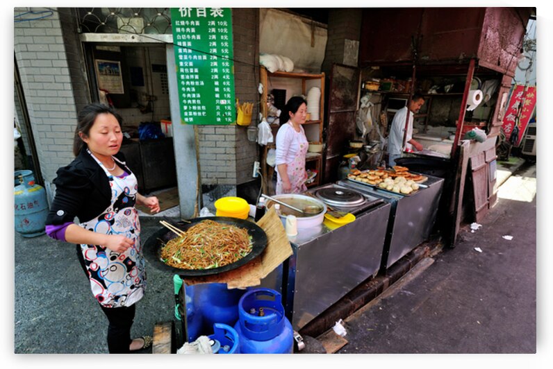 Vendors prepare noodles and fried items in Shanghai street marke by Marco Brivio