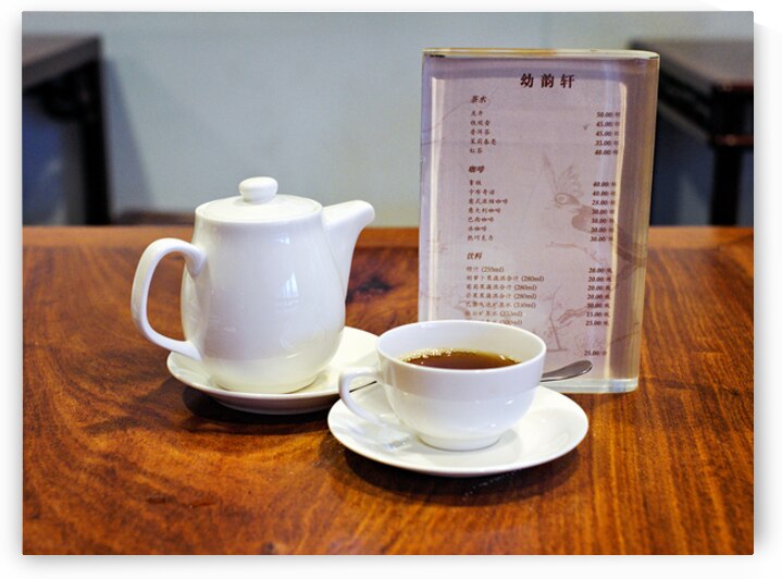 Enjoying tea and menu on a wooden table in Shanghai by Marco Brivio