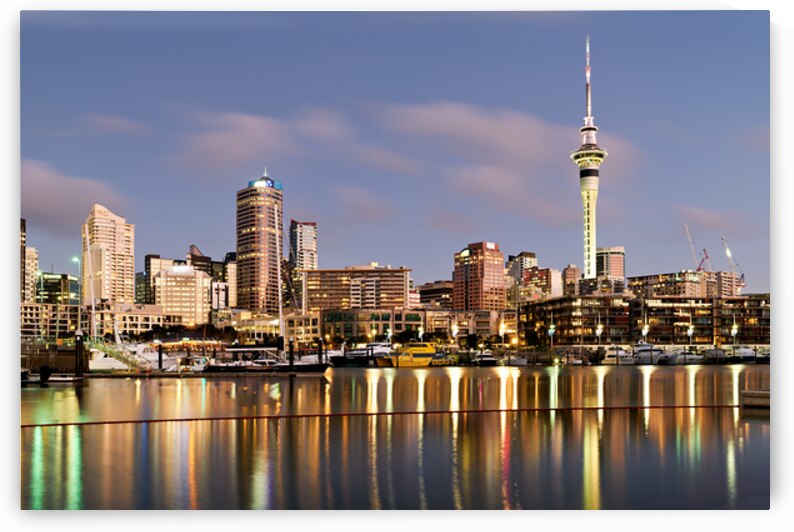 Auckland skyline with buildings and Sky Tower during evening by Marco Brivio