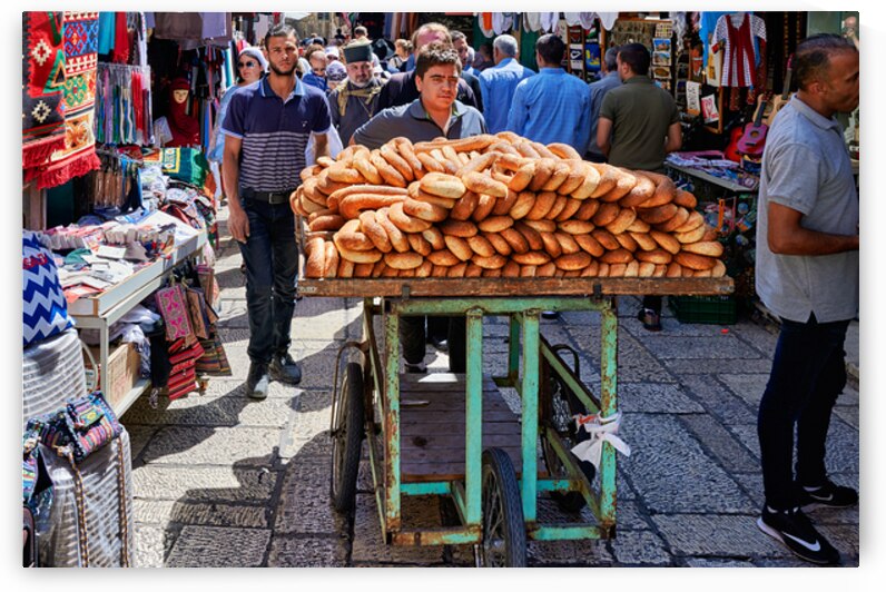 Carrying bread through the streets of old Jerusalem in Israel by Marco Brivio