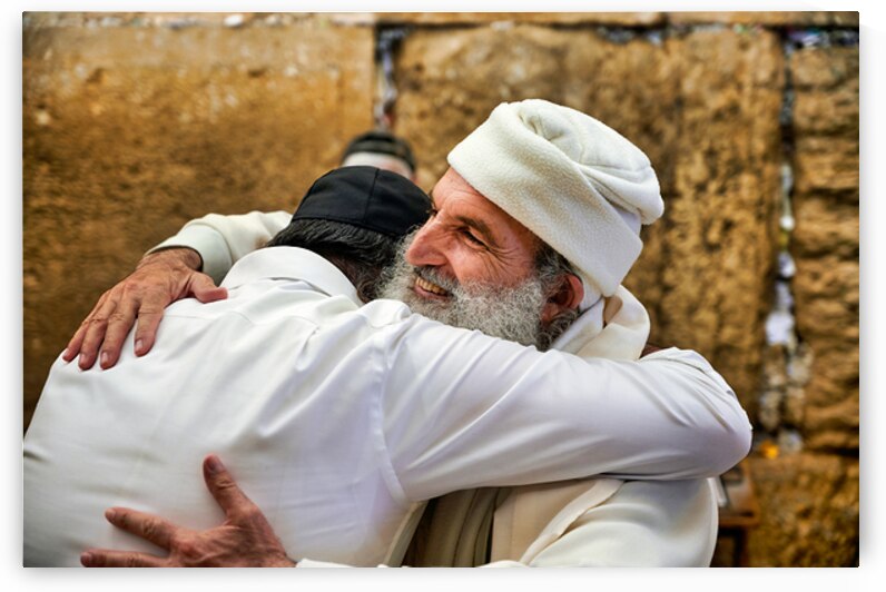 Men embrace each other at the Wailing Wall in Jerusalem by Marco Brivio
