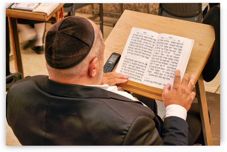Orthodox jew praying with a book at the wailing wall in jerusale by Marco Brivio