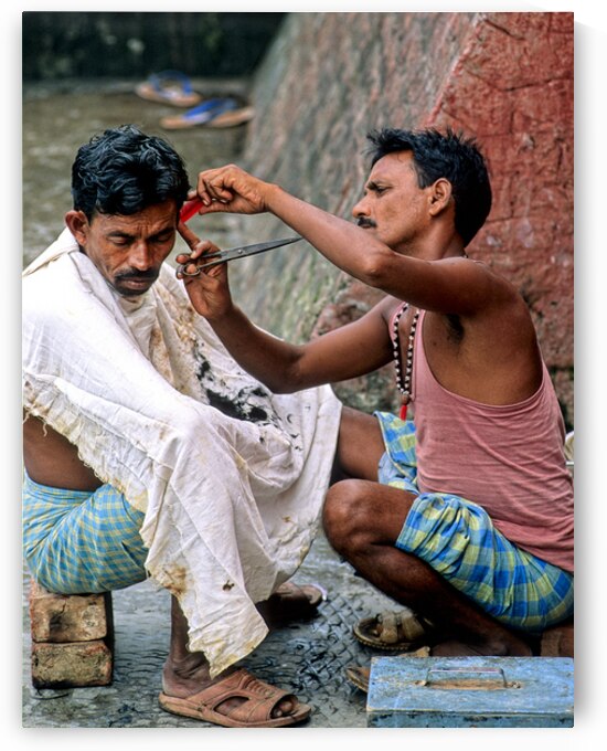 Street barber at work in Kolkata on a busy urban day by Marco Brivio