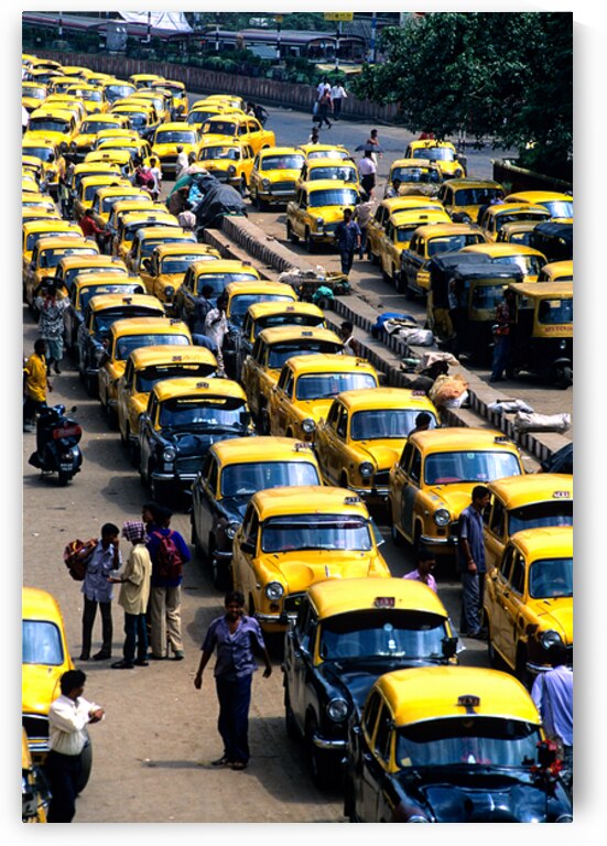 Taxi parking in Kolkatas busy streets during daytime by Marco Brivio