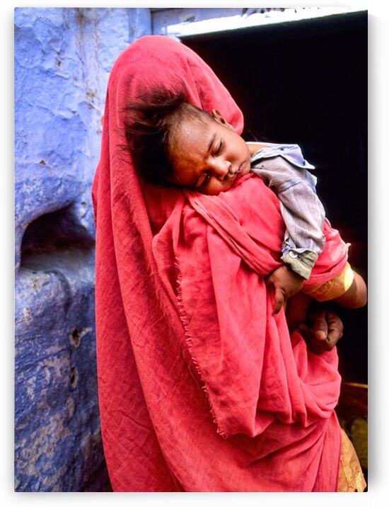 Mother carries sleeping child in India during daytime by Marco Brivio