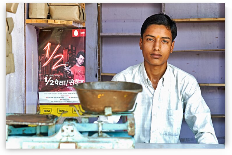 Portrait of a boy in Khimsar Rajasthan in a shop setting by Marco Brivio