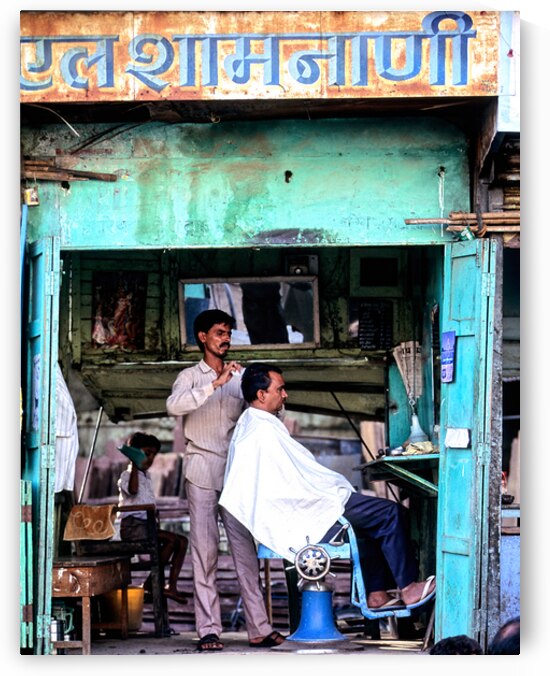 Barber performing haircut in Jaipurs local shop in Rajasthan by Marco Brivio