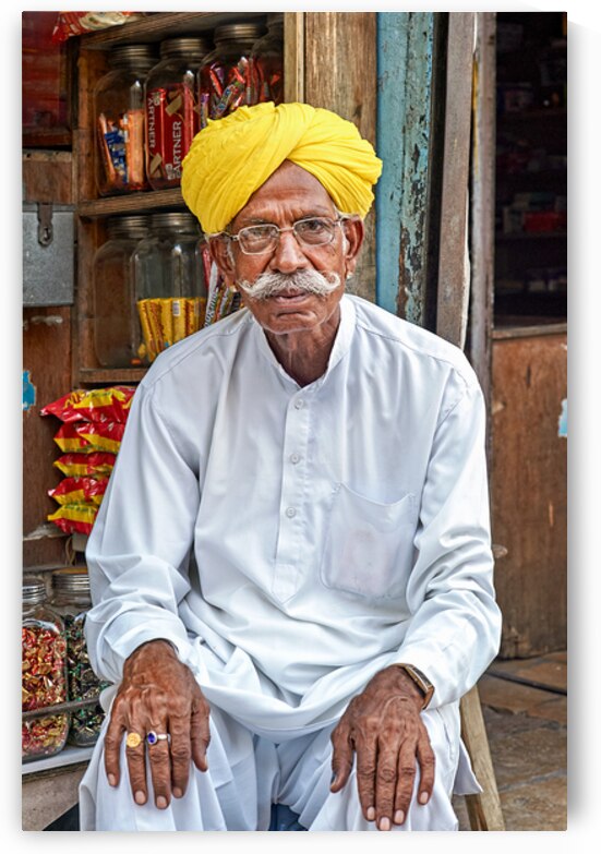 Senior man sitting in Jaisalmer market in Rajasthan India by Marco Brivio