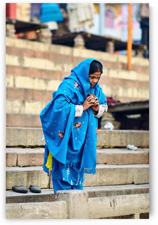 Woman praying by the Ganges in Varanasi during morning hours by Marco Brivio