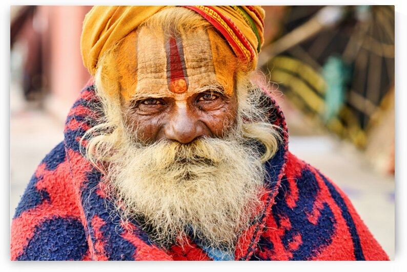 Old holy man in Varanasi wearing bright colors in Uttar Pradesh by Marco Brivio