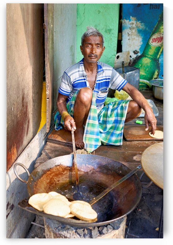 Cooking sweets in Varanasi street market during daytime by Marco Brivio