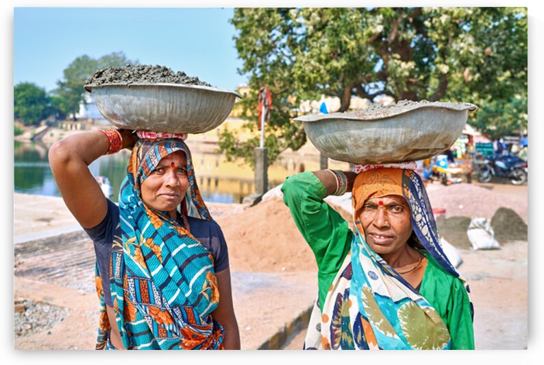 Women carry materials in Varanasi near the river bank by Marco Brivio
