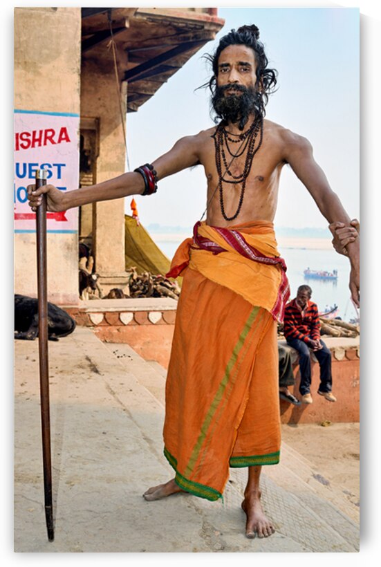 Sadhu stands near the Ganges River in Varanasi India by Marco Brivio