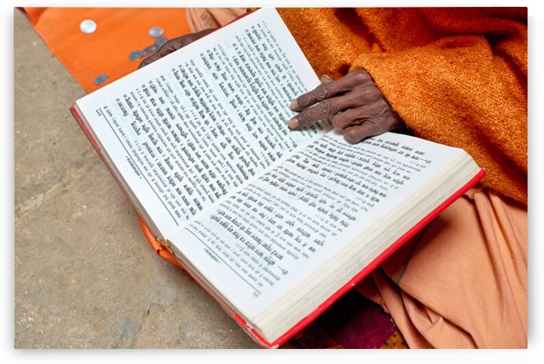 Man reads Hindu texts and prays in Varanasi India by Marco Brivio