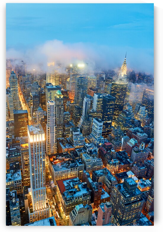 Dusk view of Manhattan showing city lights and skyscrapers by Marco Brivio