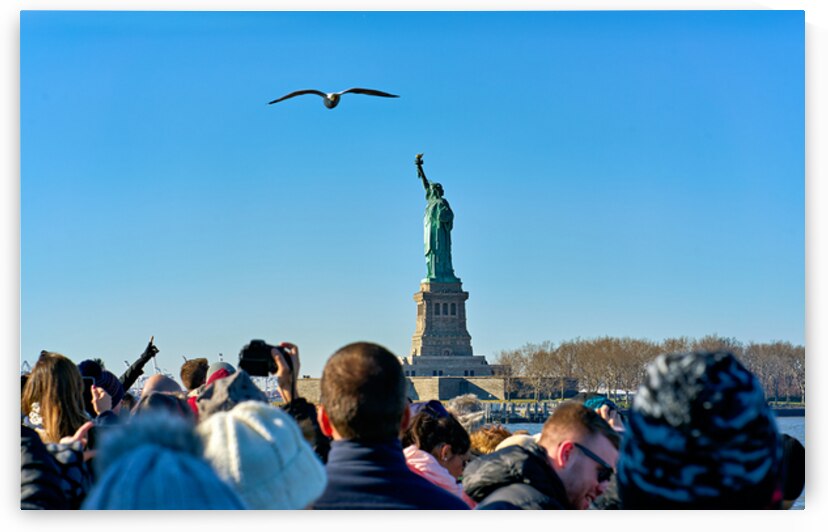 Tourists travel to Liberty Island by ferry in Manhattan New Yor by Marco Brivio