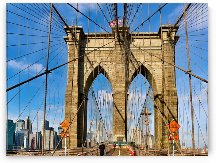 Walking on Brooklyn Bridge in New York City on a clear day by Marco Brivio