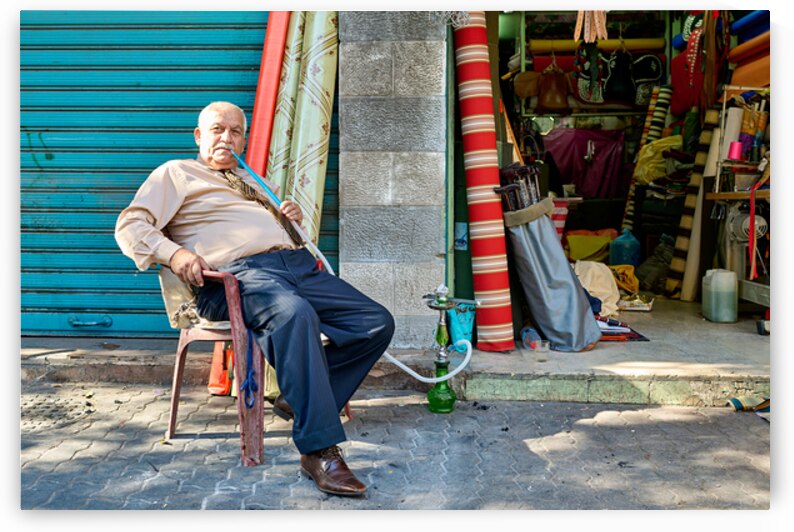 Senior citizen smokes shisha by shop in Amman Jordan by Marco Brivio