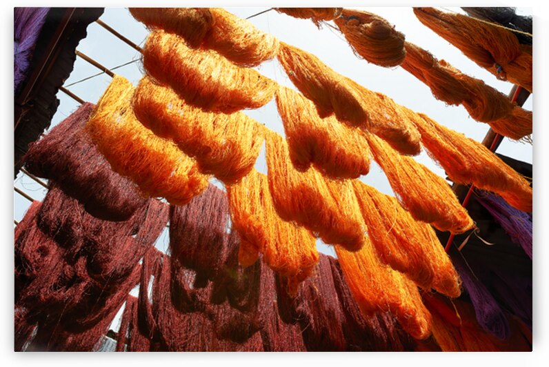Colorful threads hanging in the dyers souk of Marrakesh Morocco by Marco Brivio