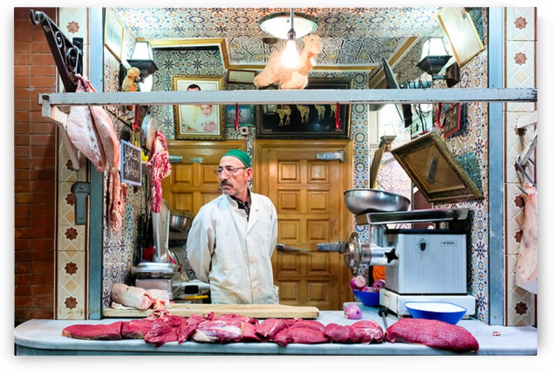 Butcher sells camel meat in the souk of Meknes Morocco by Marco Brivio