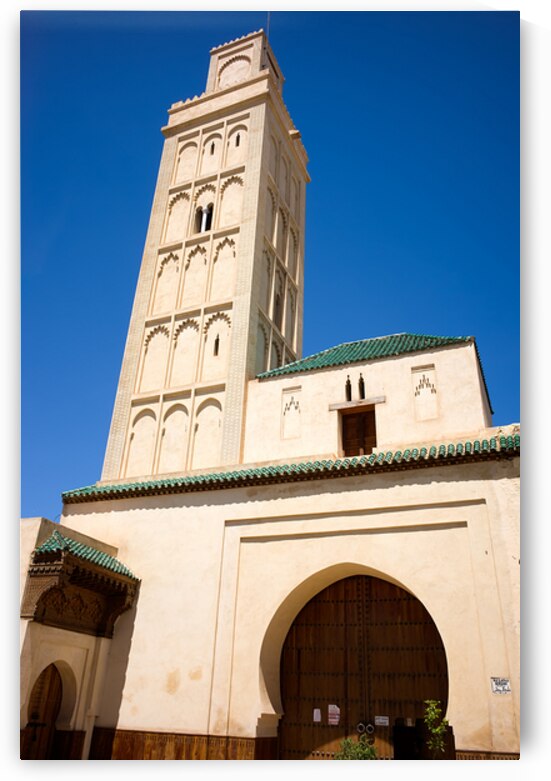 Visit Meknes mosque in Morocco with a tall tower and clear sky by Marco Brivio