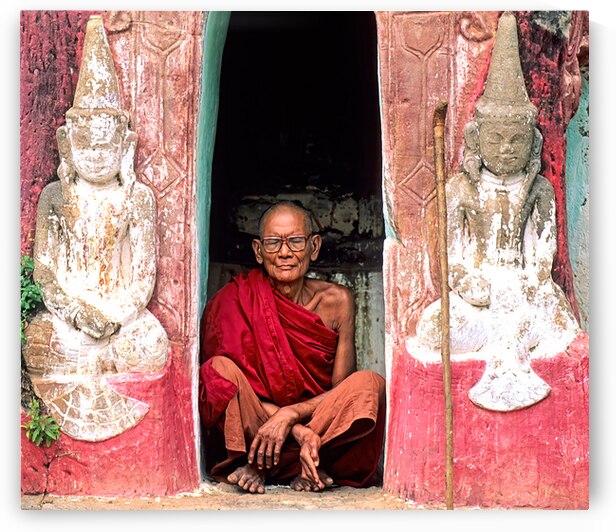 Old monk meditates in temple doorway in Myanmar by Marco Brivio