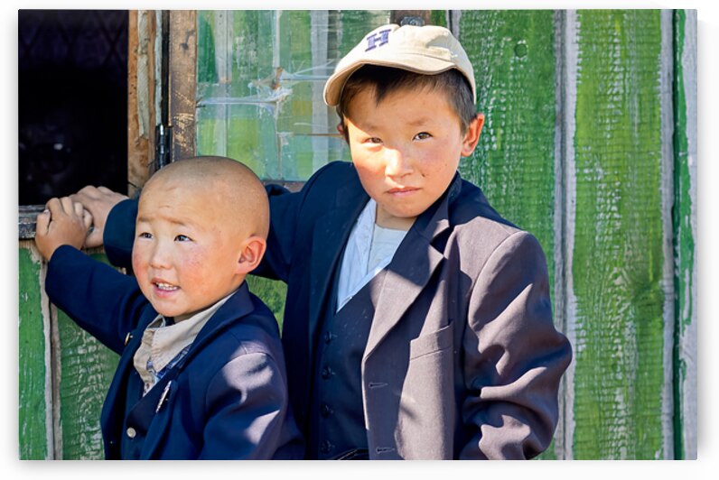 Children in Mongolia standing by a green wooden door by Marco Brivio
