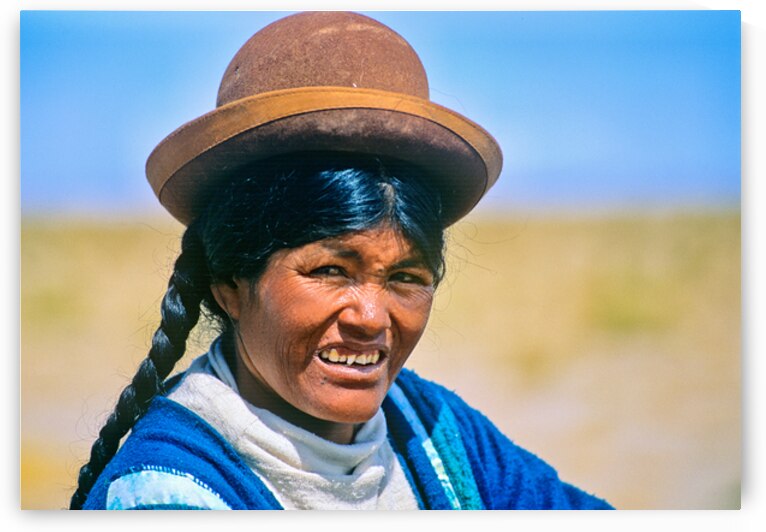 Smiling indigenous woman in hat and braid. by Marco Brivio