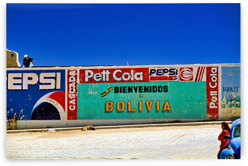 Welcome to Bolivia sign on a wall with old ads. by Marco Brivio