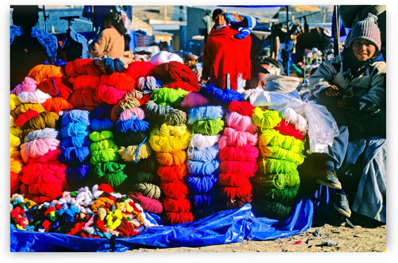 Vibrant market stall with colorful yarn and a smiling child. by Marco Brivio