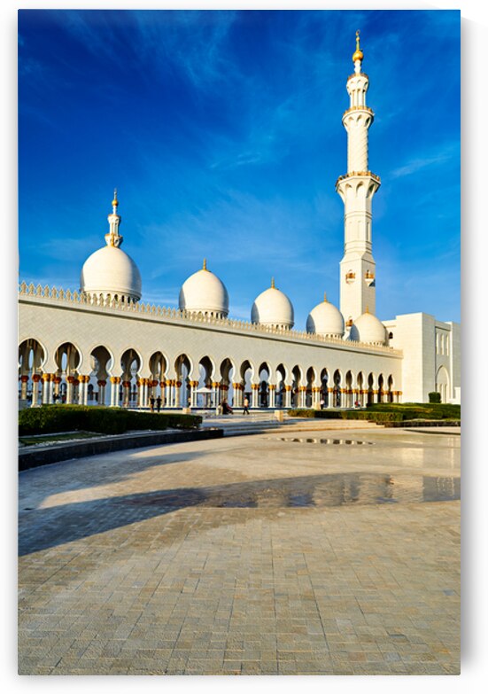 Beautiful mosque stands tall in Abu Dhabi under blue sky by Marco Brivio