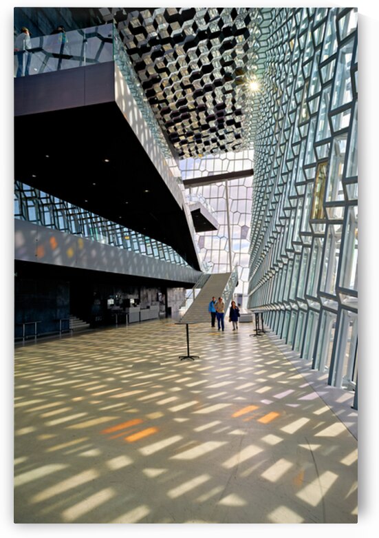 Visitors walk through Harpa Opera House in Reykjavik Iceland by Marco Brivio