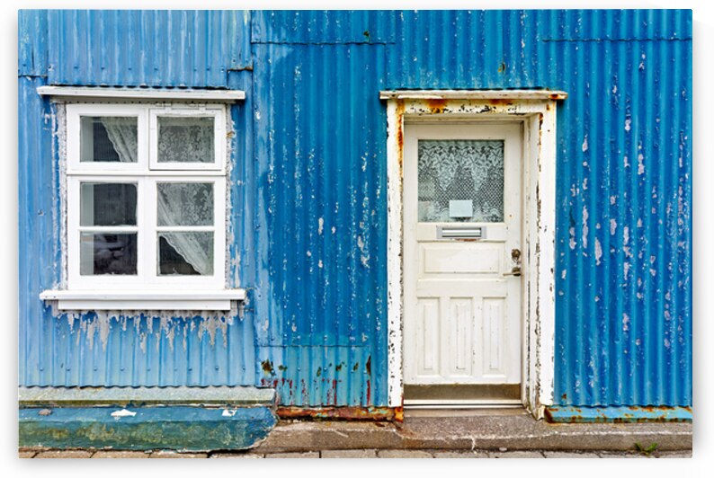Old house exterior in Isafjordur Iceland with blue wall by Marco Brivio