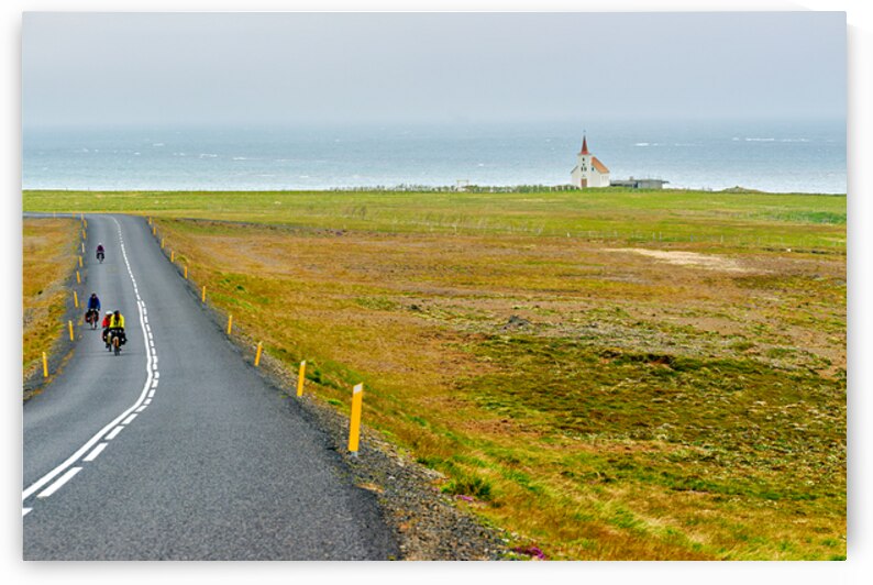 Cyclists riding near Kollafjardarnes Church in Iceland by Marco Brivio