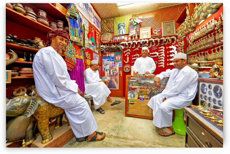 Men sit and talk in shop at Mutrah Souq in Muscat Oman by Marco Brivio