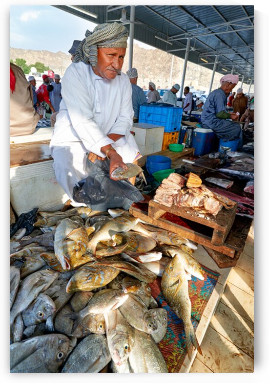 Fish sellers at Muscat Oman market display fresh catch by Marco Brivio