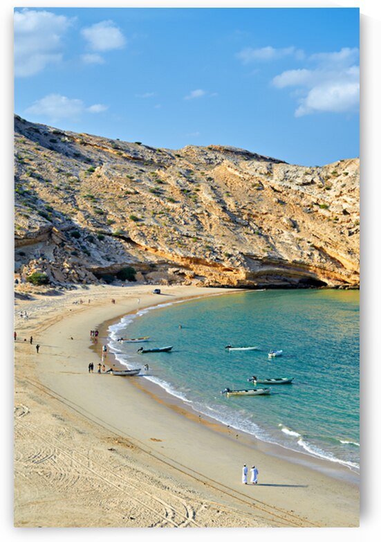 Muscat Oman beaches with boats and people walking along shore by Marco Brivio