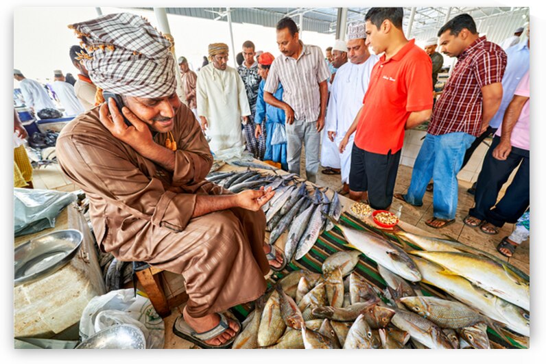Fish market scene in Muscat Oman with vendors and buyers by Marco Brivio