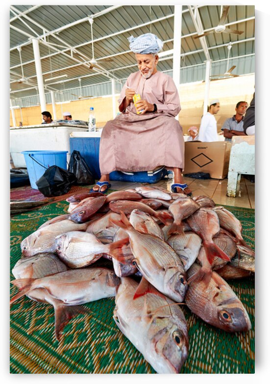 Man sells fresh fish at Muscat Oman fish market today by Marco Brivio