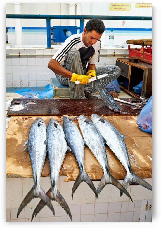 Fish seller prepares catch at Nizwa Oman fish market by Marco Brivio