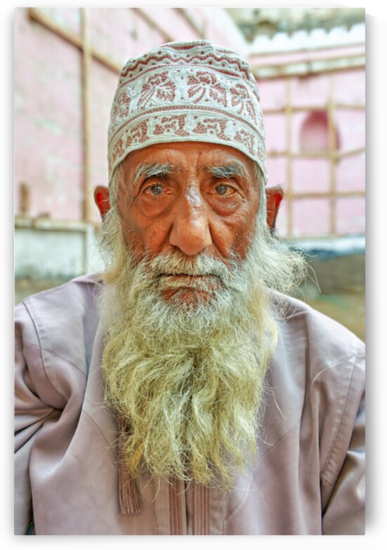 Senior man with white beard in Muscat Oman courtyard by Marco Brivio