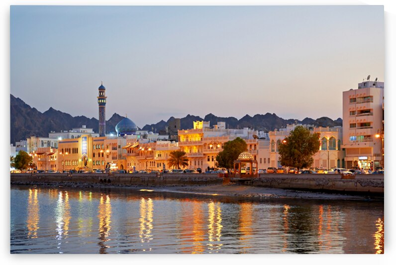 Sunset view of waterfront in Muscat Oman with city lights by Marco Brivio