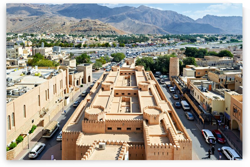 Cityscape view of Nizwa Oman with mountains and buildings by Marco Brivio