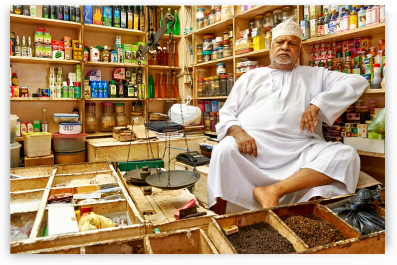 Elderly shopkeeper in his store in Muscat Oman during the day by Marco Brivio