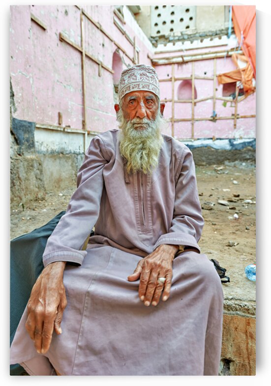 Old man sitting in a historical site in Muscat Oman by Marco Brivio